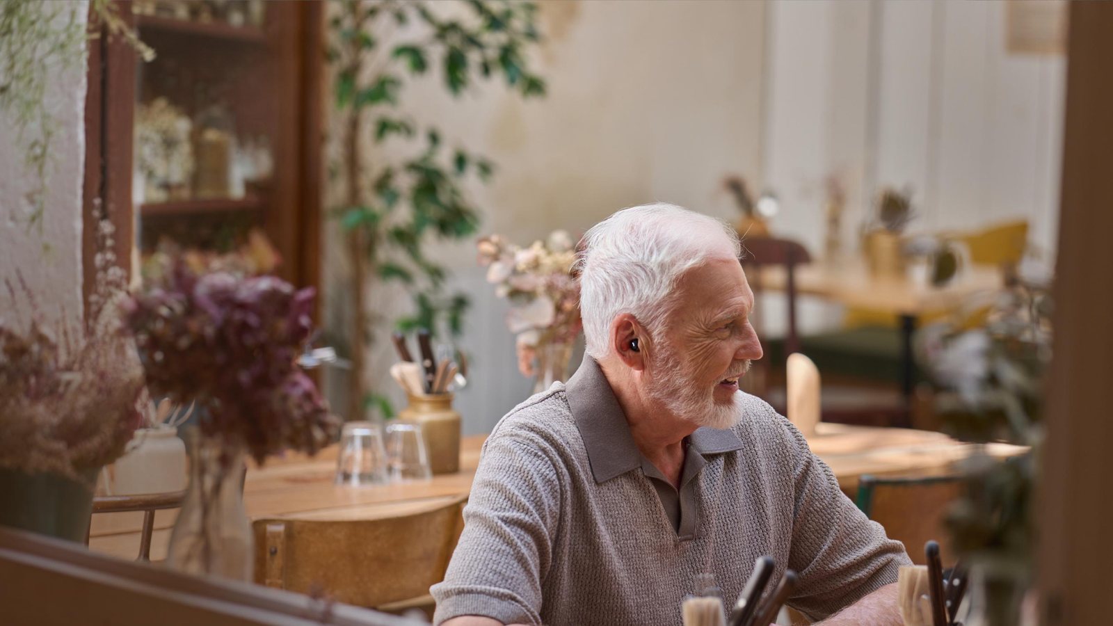 Patient in a café straining to follow conversation